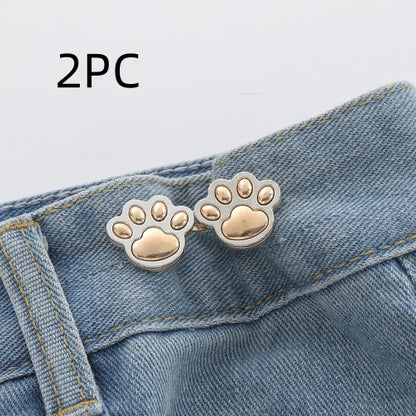 Two sets of bright gold paw waist adjusters on a denim waistband, labelled 2PC