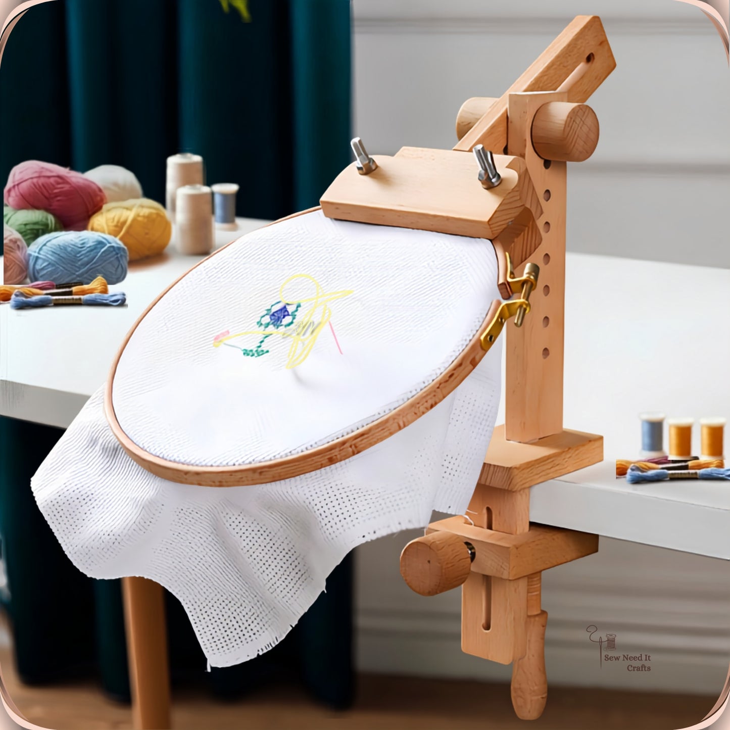 Beechwood clamp-on embroidery hoop stand fixed to a white table edge, holding an embroidery hoop with a part-stitched floral design