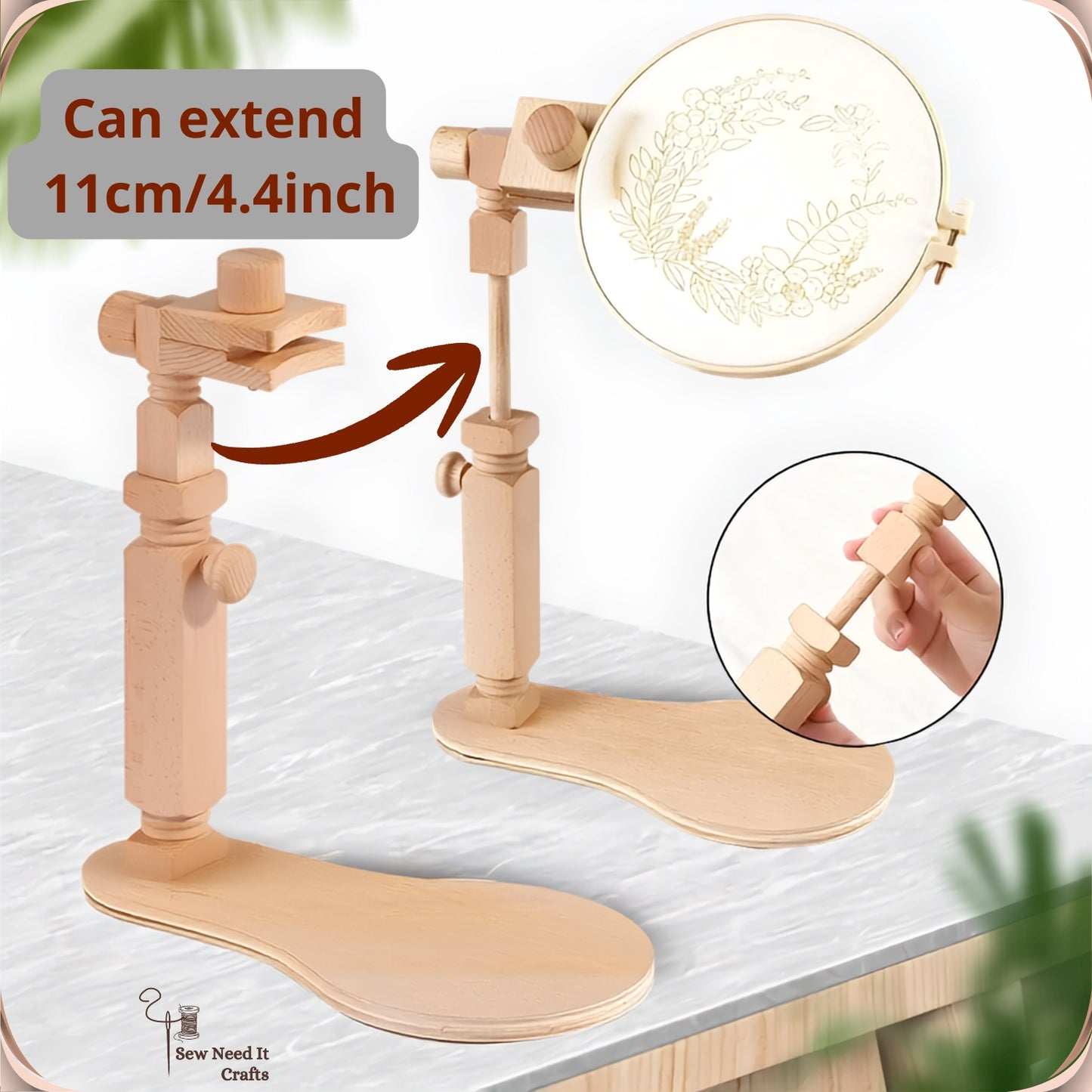 The stand shown low and raised on a tabletop, extending 11 cm to bring the hoop up to eye level