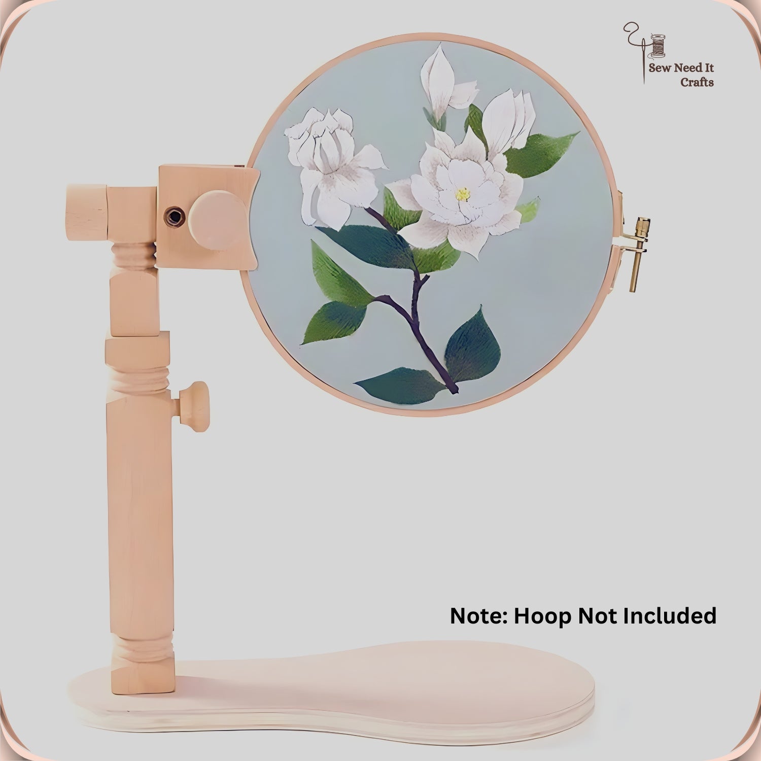Side view of the beechwood stand holding a hoop of white magnolia embroidery, with the height knob and clip visible