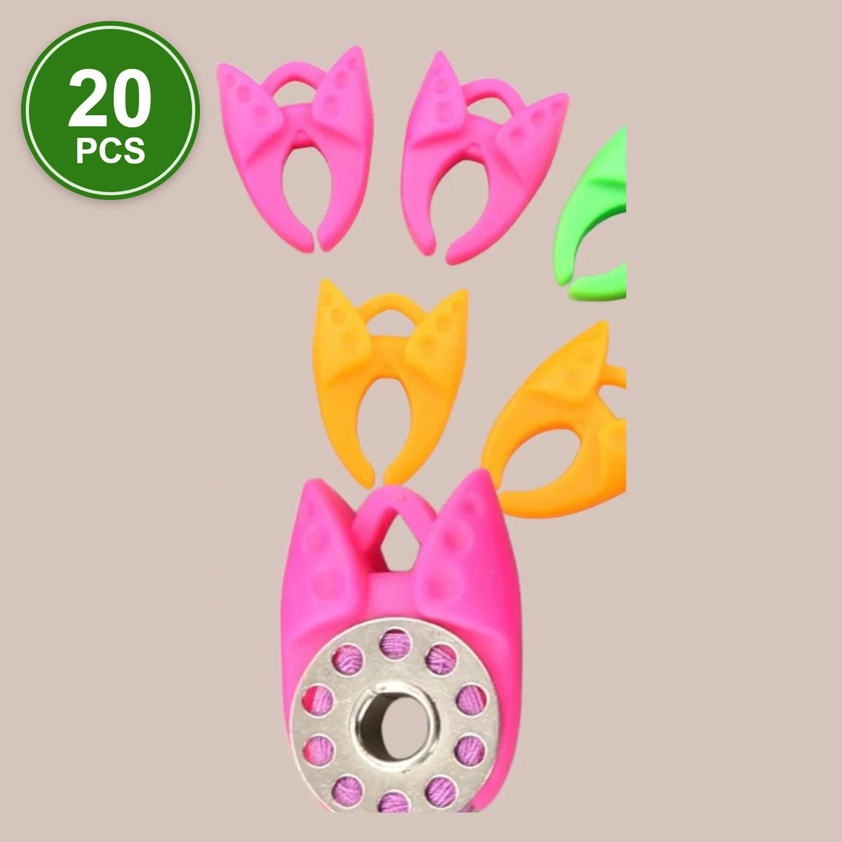 #2 Bobbin Clamps, 20 pcs: pink, orange and green silicone bobbin clamps, one holding a metal bobbin