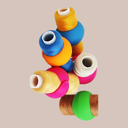 Silicone spool huggers wrapped around wound thread spools, style #3