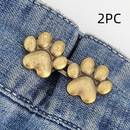 Two sets of bronze dog paw waist tightener buttons, one pair shown on a denim waistband, labelled 2PC