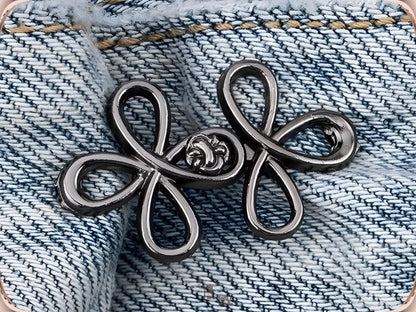 Gunmetal clover flower waist adjuster, one set, clipped to a denim waistband