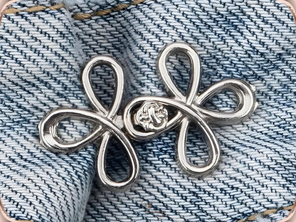 Silver clover flower waist adjuster, one set, clipped to a denim waistband