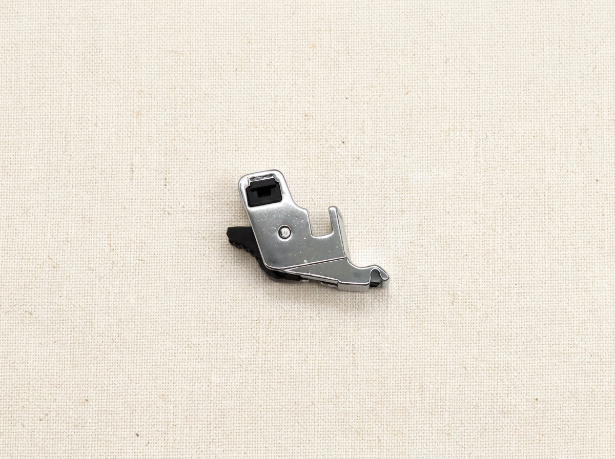 Flat lay of snap-on presser foot adapter with sewing accessories