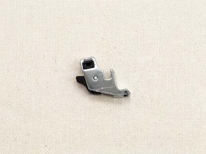Flat lay of snap-on presser foot adapter with sewing accessories