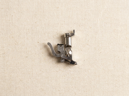 Flat lay of old style Bernina snap-on shank adapter