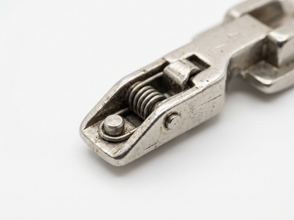 Close-up macro detail of old style Bernina snap-on shank adapter