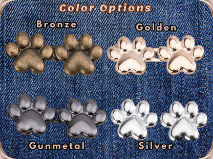 Colour options for the paw waist adjuster buttons shown on denim, labelled Bronze, Golden, Gunmetal and Silver