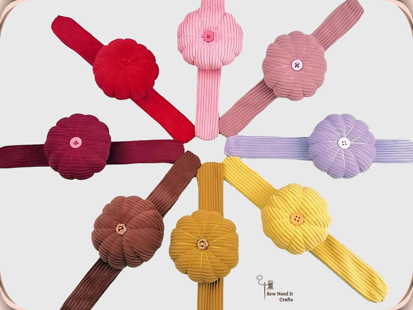Nine pumpkin wrist pin cushions arranged in a circle with their corduroy bands radiating outward, showing the full colour range