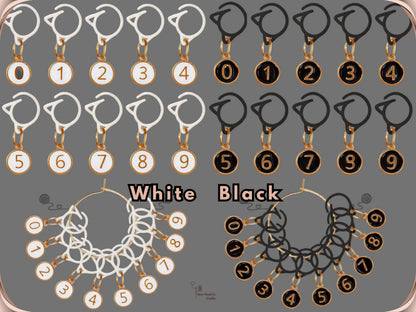 Comparison chart of the White and Black numbered stitch marker sets, each with ten matching clips and charms numbered 0 to 9, shown hanging on gold-tone storage rings