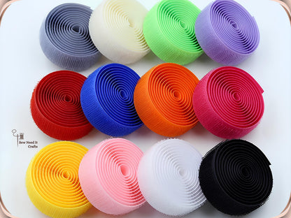 Twelve coiled rolls of 20 mm hook and loop tape in grey, cream, green, purple, red, blue, orange, pink, yellow, white and black