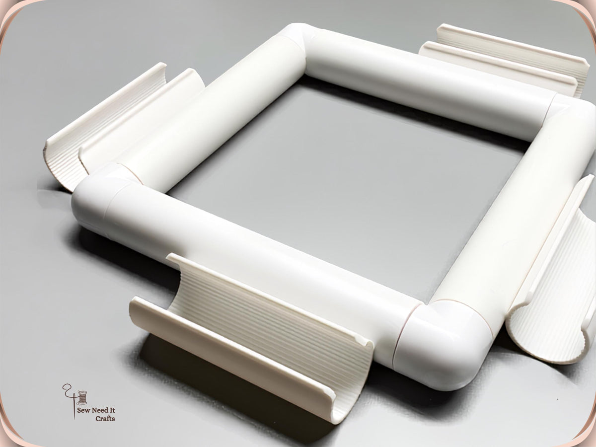 Assembled white square snap frame with its four ribbed clamps beside it