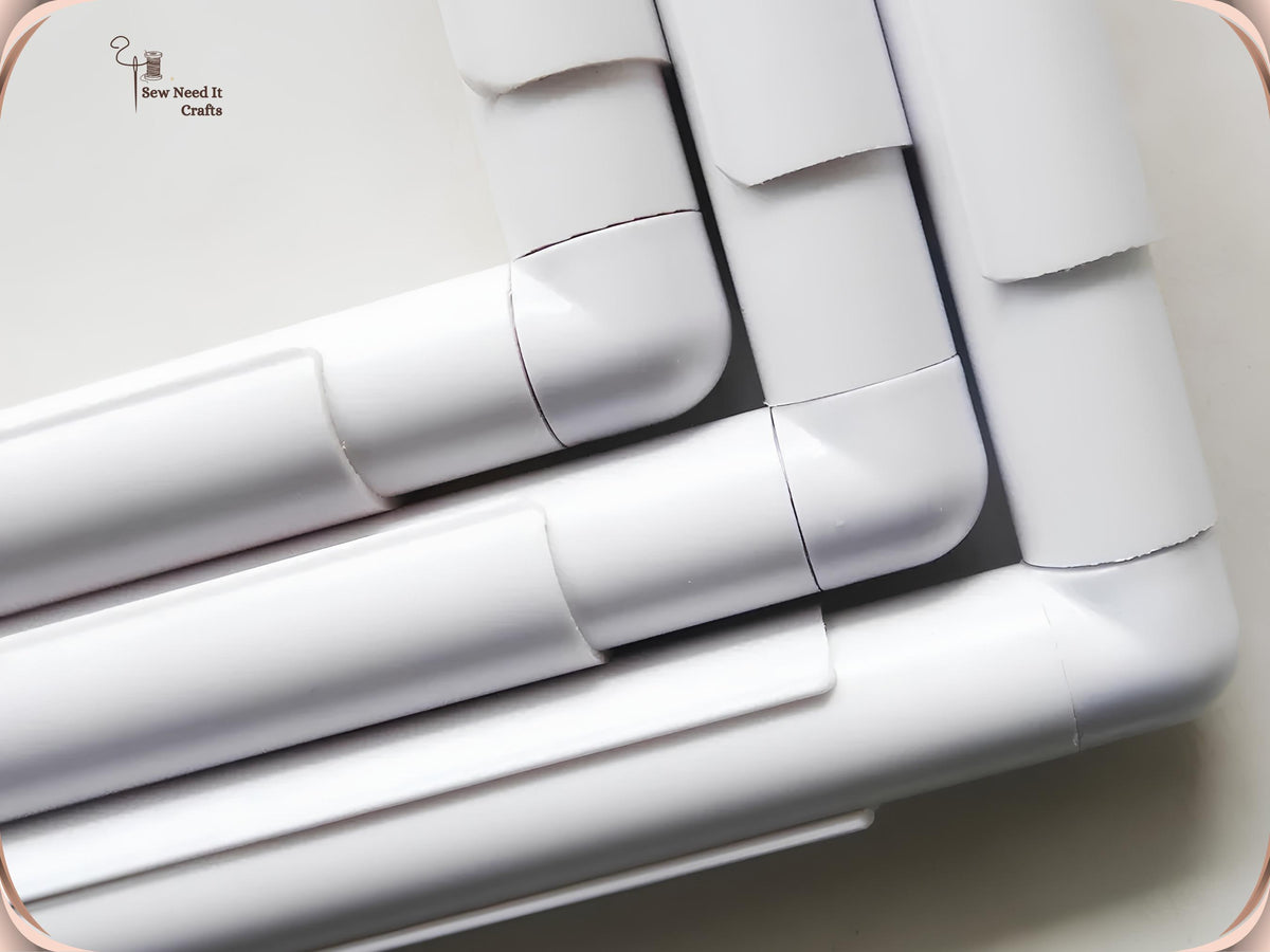 Close-up of nested white snap frame corners showing the elbow joints and clamps