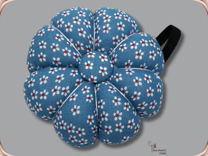 Denim Blue pumpkin wrist pin cushion with white flowers and black elastic band