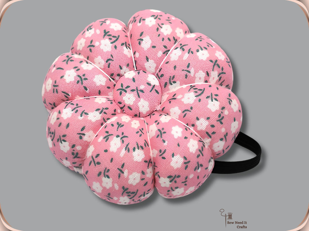 Pink floral pumpkin wrist pin cushion with black elastic band