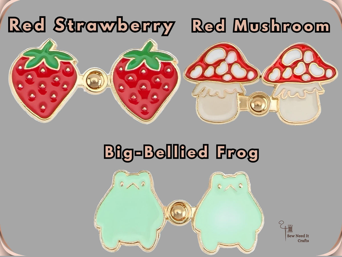 The three designs: Red Strawberry, Red Mushroom and Big-Bellied Frog waist tightener pins
