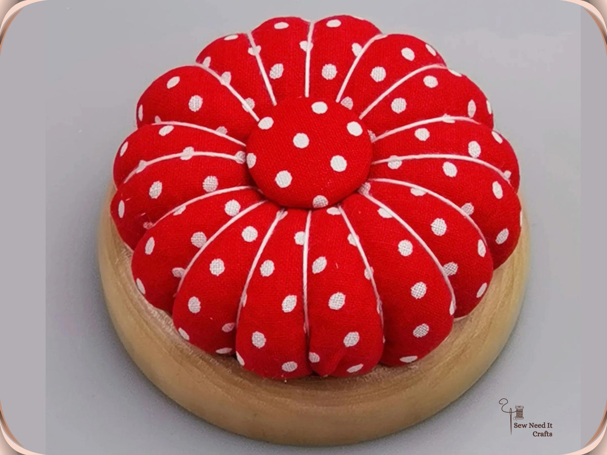 Red Polka Dot pumpkin pin cushion on a natural wooden base