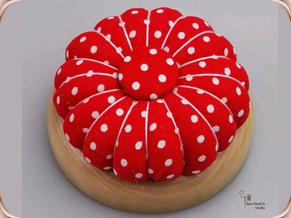 Red Polka Dot pumpkin pin cushion on a natural wooden base