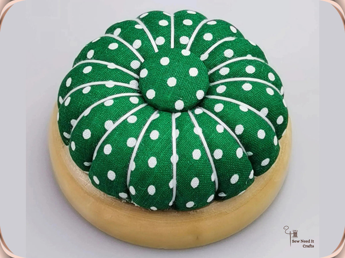 Green Polka Dot pumpkin pin cushion on a natural wooden base