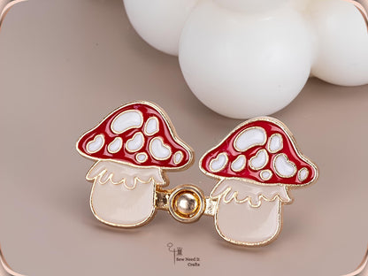 Close-up of red mushroom waist tightener pins snapped together with a gold-tone peg and ring