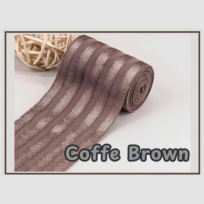 Coffee brown 2 inch satin stripe elastic band for sewing, partly rolled and labelled Coffee Brown
