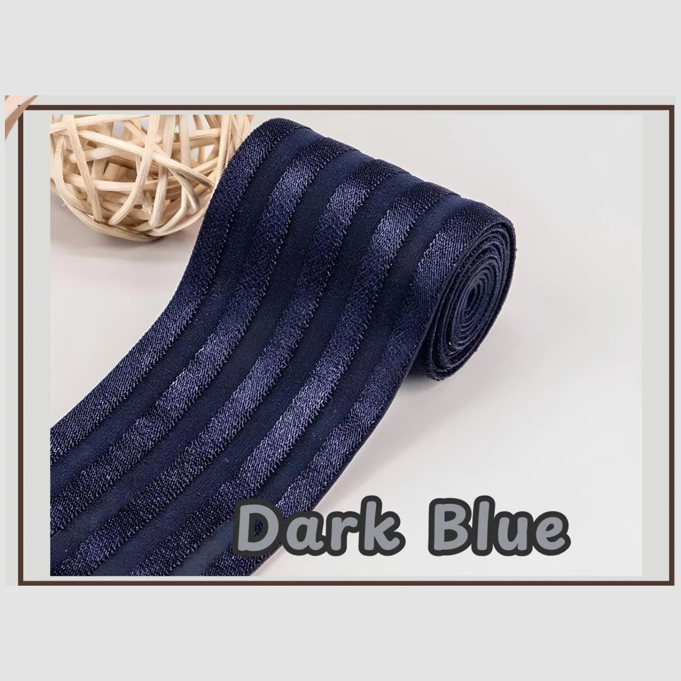 Navy 2 inch satin stripe elastic band for sewing, partly rolled and labelled Dark Blue