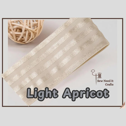Light apricot 2 inch satin stripe elastic band for sewing, folded flat and labelled Light Apricot
