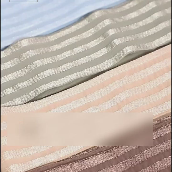 Video showing the 2 inch striped elastic band being stretched, shown in several colors, measured with a digital caliper at about 1 mm thick, soaked and wrung out in clear water with no color bleeding, and used as a decorative side panel on trousers