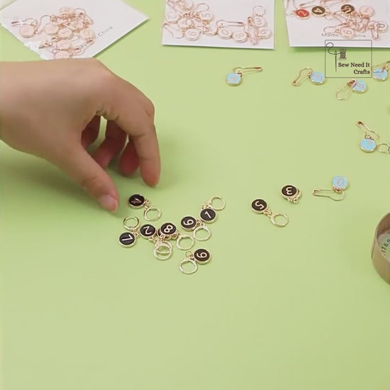 Video showing the hinged clasp opening and closing, and numbered stitch markers being clipped into a crochet project as it is worked