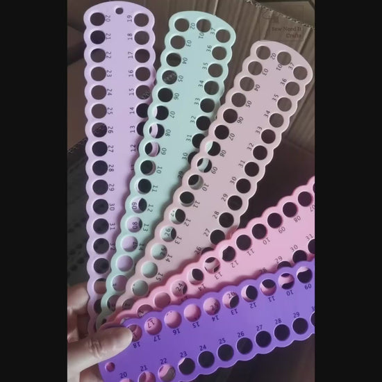Video: numbered floss drop boards fanned out in several colours, floss looped through the numbered holes and boards laid flat