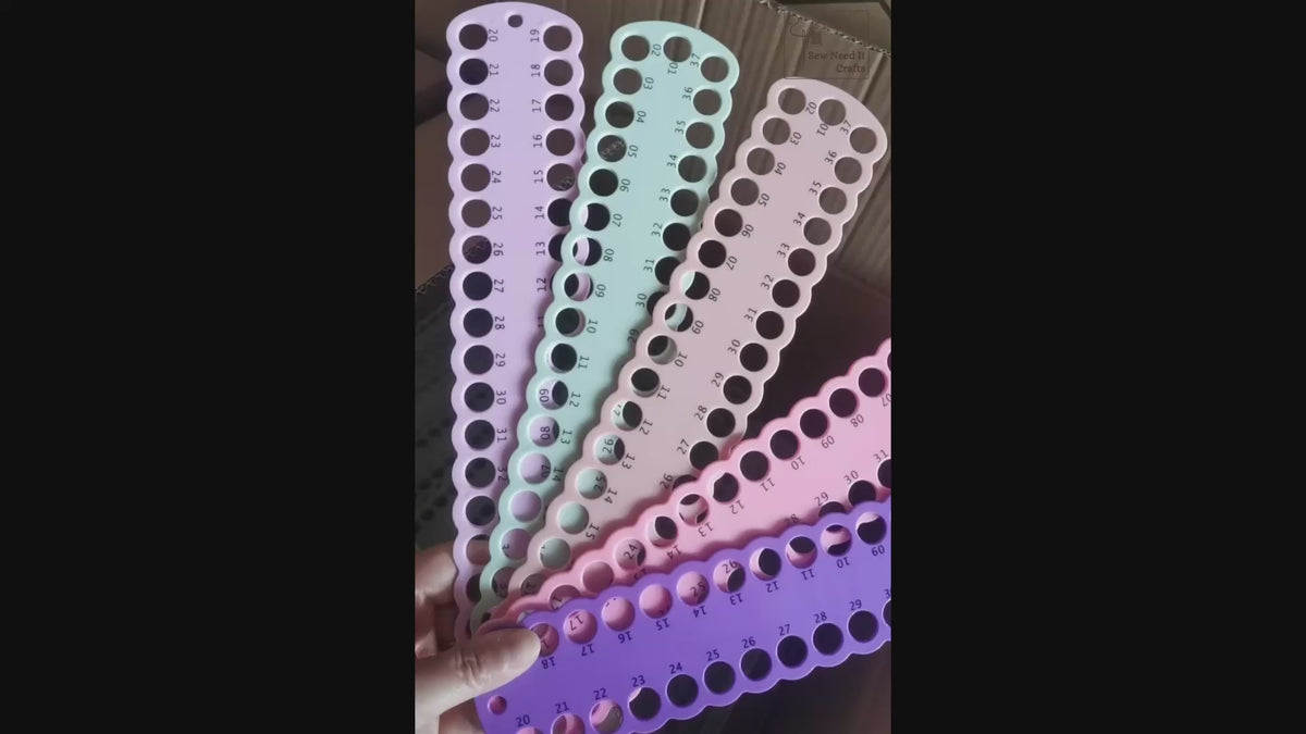 Video: numbered floss drop boards fanned out in several colours, floss looped through the numbered holes and boards laid flat