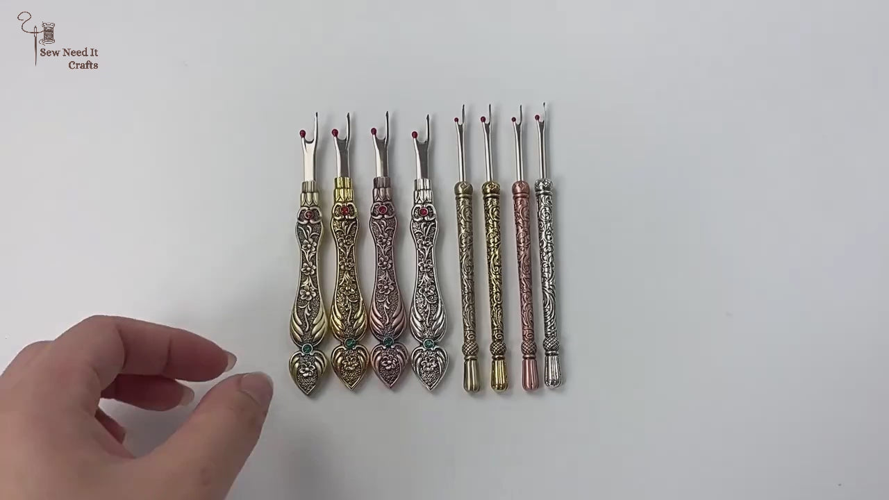 Video showing the full range of vintage style seam rippers in both flat and round handles, close-ups of the engraved metal and the stainless fork blade with its red safety ball, and the tool unpicking a machine-sewn seam in cotton fabric