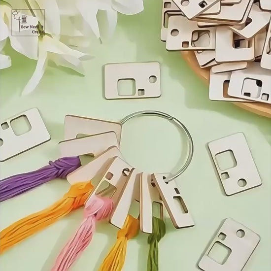 Video: embroidery floss looped through wooden floss bobbins on a metal ring, used beside an embroidery hoop, with the range of board shapes