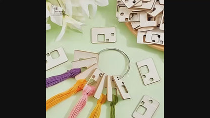 Video: embroidery floss looped through wooden floss bobbins on a metal ring, used beside an embroidery hoop, with the range of board shapes