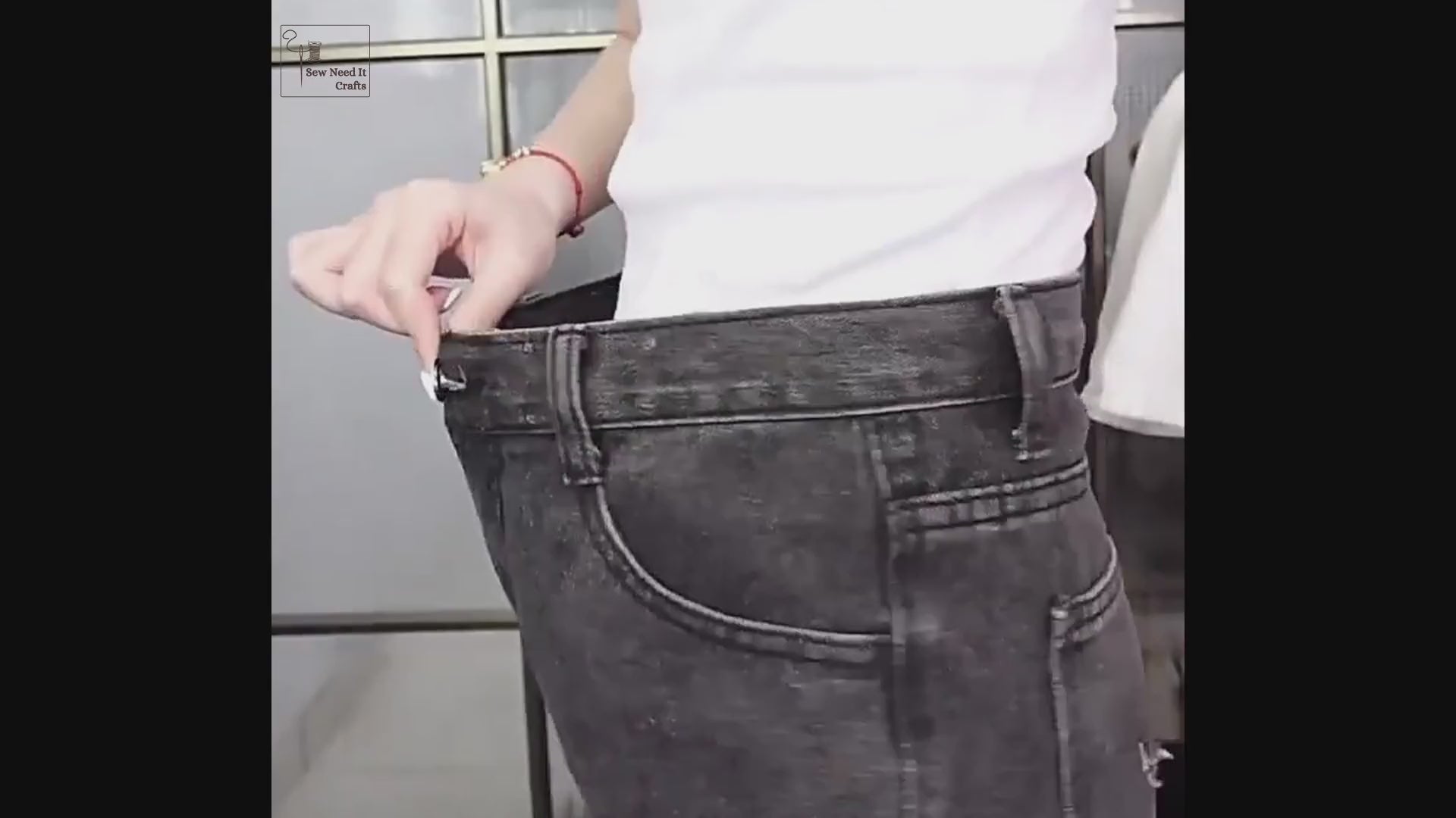 Video: strawberry, frog and mushroom waist tightener pins shown in hand, then a strawberry pair being pinned, capped and snapped together on a jeans waistband