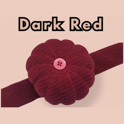Dark red corduroy pumpkin pin cushion with a pink button, on its matching band