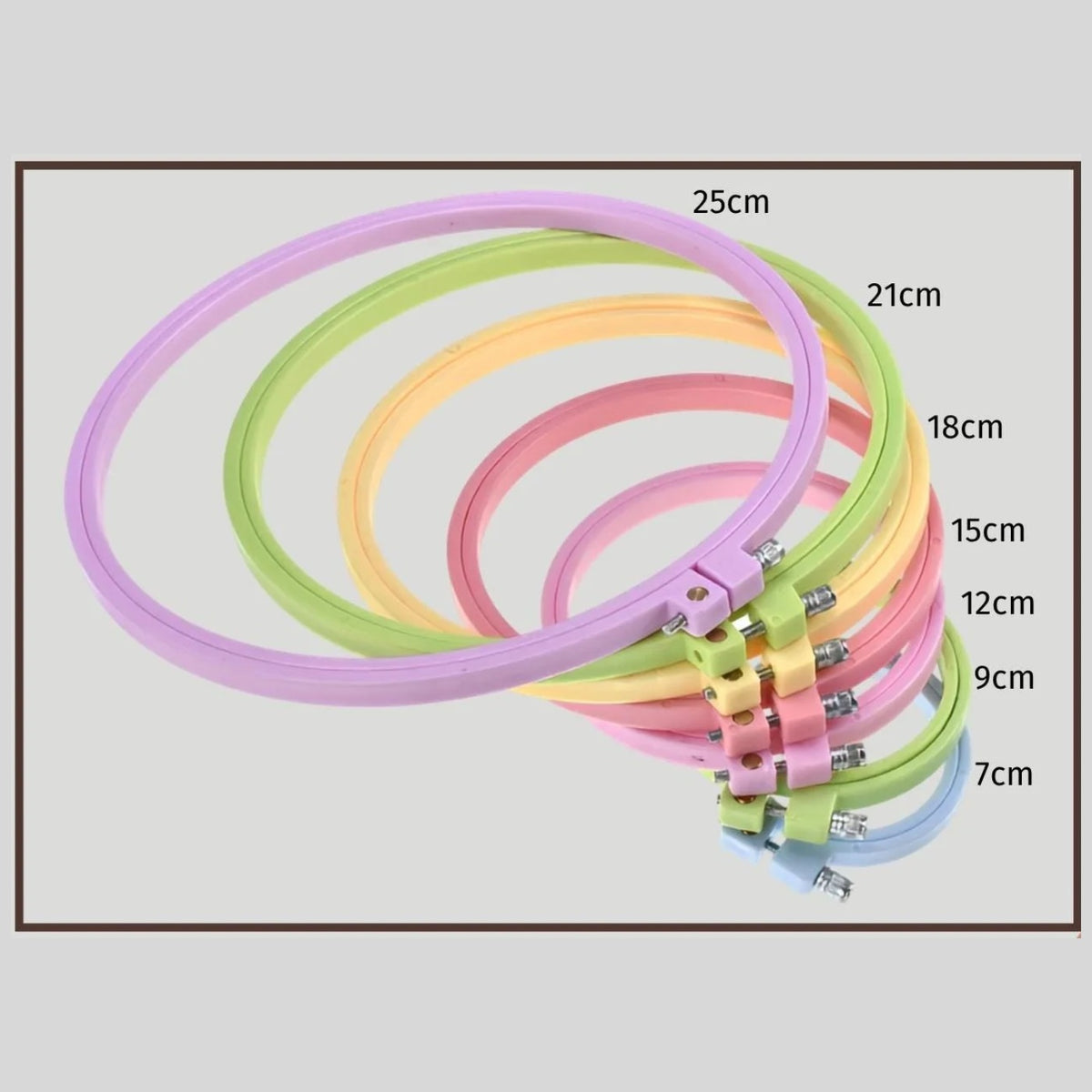 Set of seven round plastic embroidery hoops nested, 7 cm to 25 cm